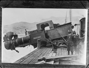 Accident showing steam engine hanging half over the edge of Lyttelton wharf, having been dropped from a crane while being loaded or unloaded
