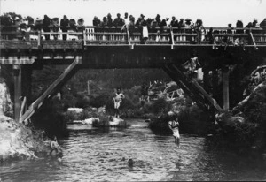 Creator unknown: Photograph of children jumping off bridge at Whakarewarewa Village, Rotorua
