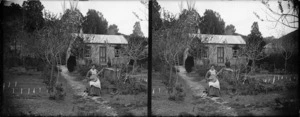 Lydia Williams holding her banjo in the garden outside her Carlyle Street house, Napier