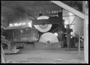 Creator unknown :Photograph of a scene in a timber mill showing circular saws in operation