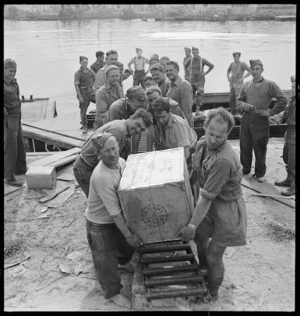 New Zealanders unloading supplies for the 8th Army, Tripoli, Libya, during World War 2 - Photograph taken by Harold Gear Paton