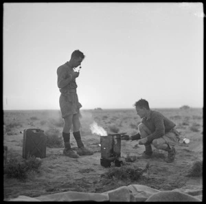 New Zealand World War II soldiers cooking around a small fire, Western Desert, North Africa