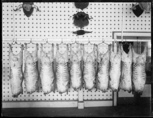 Interior of butcher shop with sheep carcasses