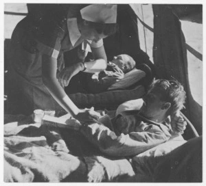 Sister J Bond with a patient at a casualty clearing station in Egypt, during World War 2