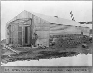 Francis E C Davies constructing a hut at Antarctica during the British Antarctic Expedition of 1911-1913
