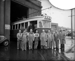 Tramways workers at the Kilbirnie workshops, alongside the last tram to be built in Wellington