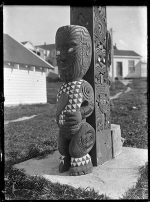 Maori carved figure at the base of a pillar