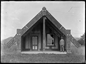 An unidentified Maori meeting house at Ohau, with Walter Percival standing on the porch