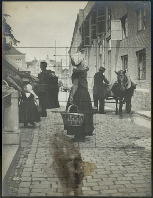 Photograph of street scene highlighting woman with cane baskets