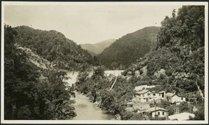 Mangahao River and houses alongside, with Mangahao dam in the background
