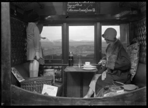 Interior of a railway carriage, showing several items of New Zealand Railways picnic equipment
