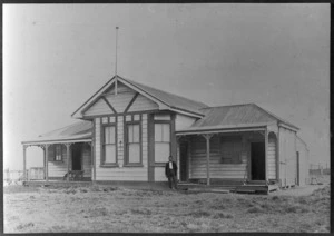 Bungalow with an unidentified man standing in front