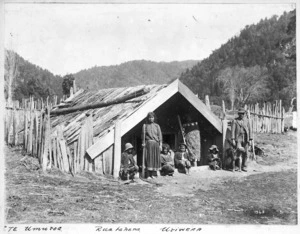 Maori group outside a whare at Te Umuroa, Ruatahuna