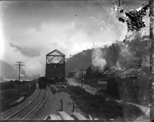 View of rear end of a train on the railway track beside the Dobson Mine coal bins, which are under construction