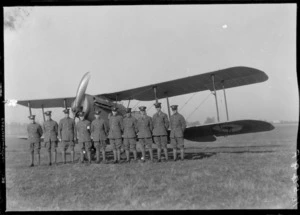 Arrival of the Southern Cross at Christchurch. Group of men in uniform posed with the plane