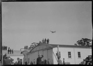 Arrival of the Southern Cross at Christchurch. Plane in flight, over hanger