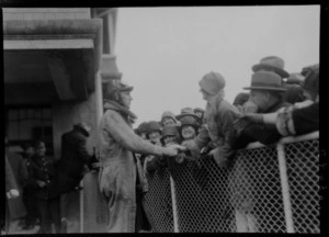 Arrival of the Southern Cross at Wellington, possibly Trentham. Radio operator T H McWilliam greeting crowd