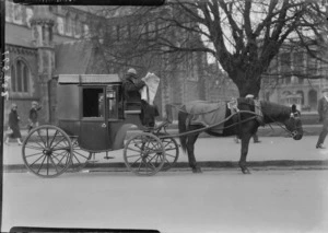 Arrival of the Southern Cross at Christchurch. Cabby on horse drawn carriage, reading newspaper