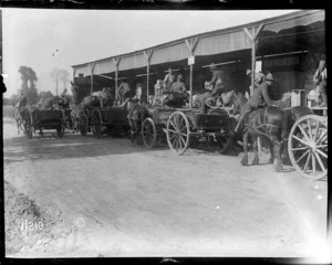 Soldiers on horse drawn carts line up at the NZASC ration dump, Steenbecque, France