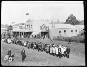 Children standing in a line, along an unidentified street in Tolaga Bay - Photograph taken by Frederick Ashby Hargreaves