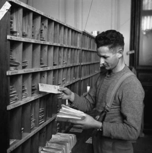 World War II soldier sorting letters at Cairo Base post office