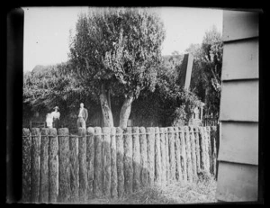 Scene including ponga log fence and unidentified people, Chatham Islands