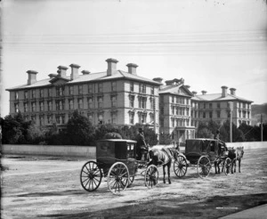 Two horse drawn cabs outside Government Buildings, Wellington