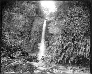 Unidentified man seated in front of the Ferntown Waterfall