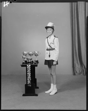 Unidentified member of the Crystal Cadets marching team of 1969 with trophies
