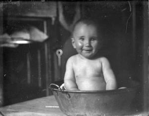 Baby in a metal bath tub