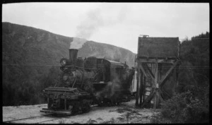 Climax steam locomotive beside a water tower