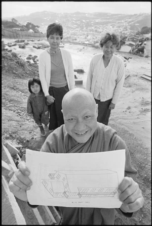 Photograph of senior monk venerable Suthep Surapong holding a sketch of a proposed Buddhist monastery, Dart Crescent, Wellington - Photograph taken by Mark Round