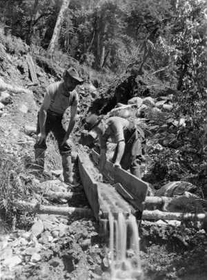 Two men sluicing for gold in the Howard River area, Tasman District