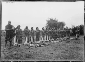 Row of women with poi, at Kaiwhaiki - Photograph taken by William Henry Thomas Partington