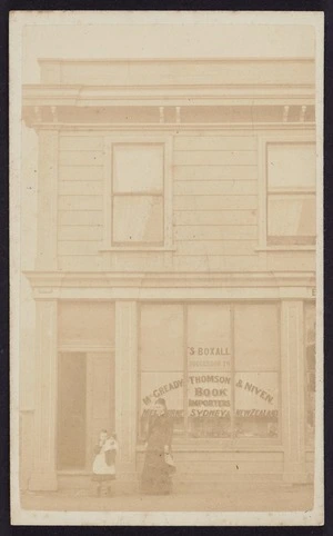 Photographer unknown :Portrait of woman and child in front of the business premises of S Boxall