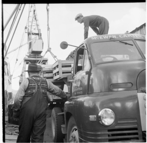 Maori man, in the drivers seat of a McEwen Carter & Co truck, Wellington Wharves