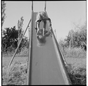 Maori children playing on a slide