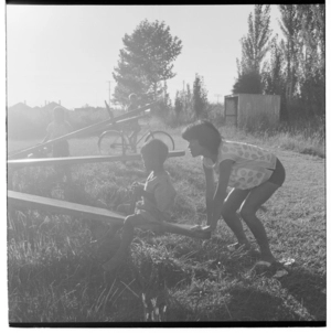 Maori children playing on a see-saw