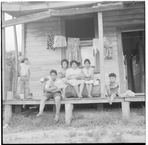 Maori group on the verandah of a house at Pipiriki