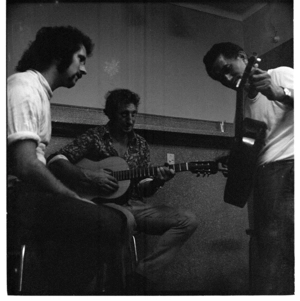 Inside a pub at Waihi, Coromandel, Barry Crump and friends. 1971