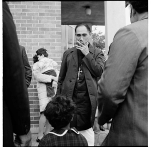 Samoan congregation outside a Catholic (?) church, Great North Road, Grey Lynn; and a family passing Mid City Motors, Great North Road, Grey Lynn, Auckland