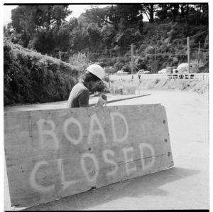 A road worker manning a 'Road closed' sign, 1974.