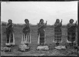 Row of women with poi, at Kaiwhaiki - Photograph taken by William Henry Thomas Partington