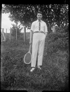 Man in tennis clothing holding a racket