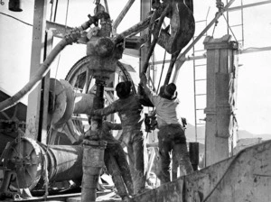 Men operating oil drilling machinery, Gisborne
