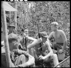 Second Lieutenant P Scott addressing New Zealand Regiment troops and marines in jungle base camp