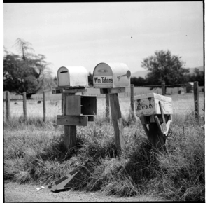 Row of letterboxes by the roadside; country scenes; and a child climbing through a fence