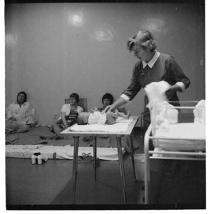 A nurse teaching women at an antenatal class in a hospital