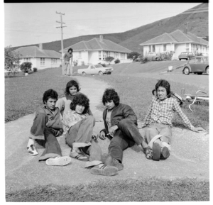 Group of young Māori lounging along a path, possibly in the Delaney Drive area of Stokes Valley