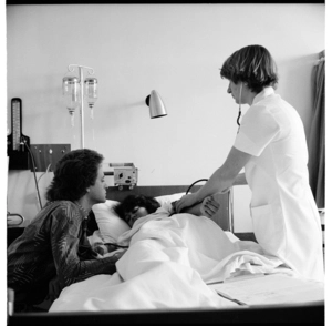 Photographs in a hospital, a woman in labour